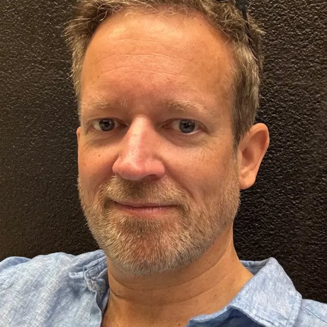 Peter, founder of ReviewBoost, smiling in a light blue shirt